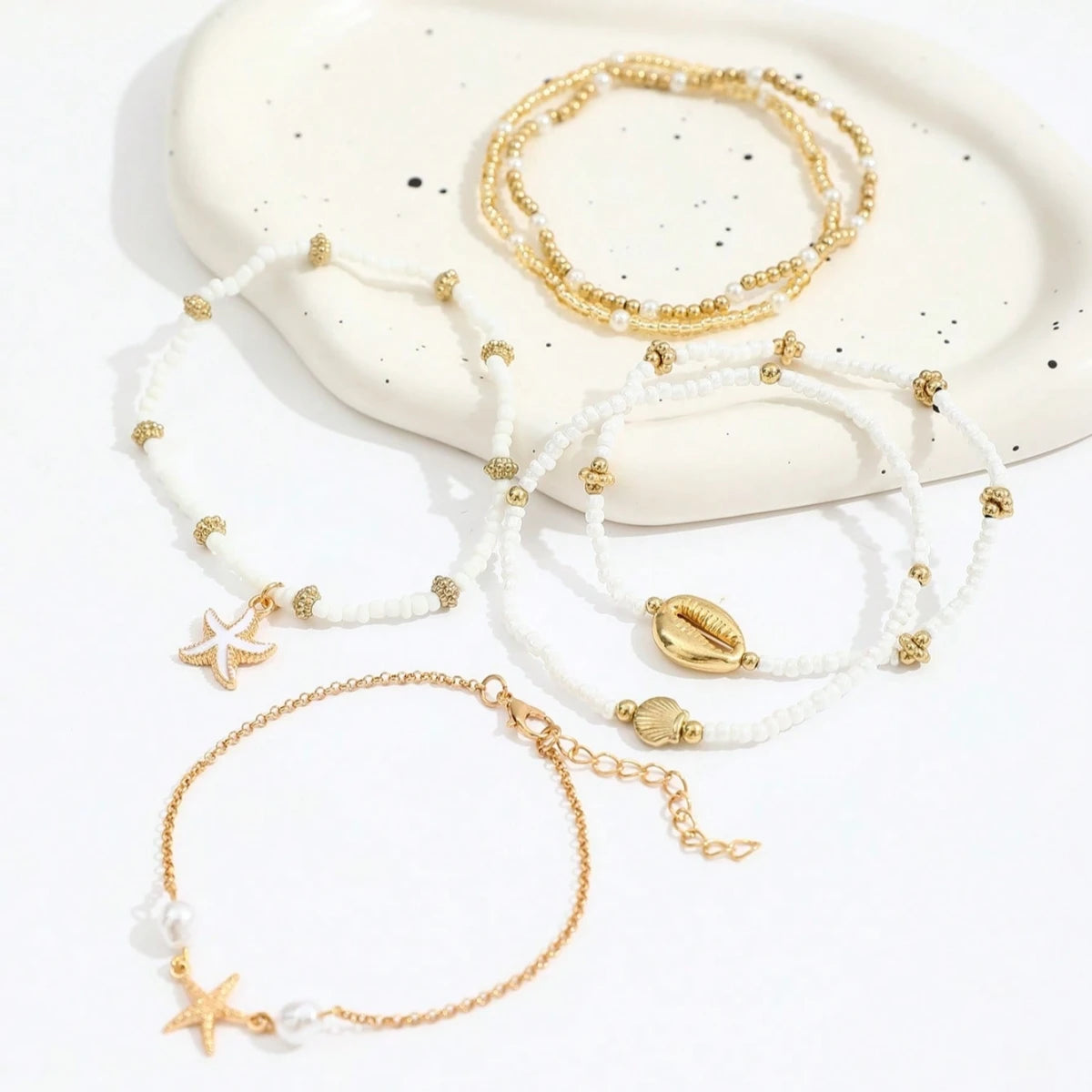 Ensemble de 6 bracelets de cheville empilables avec pendentifs en forme d'étoile de mer et coquillage, pour femme.